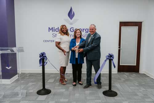 MGA representatives cutting the ribbon at the center grand opening.